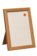 A small framed certificate-style card with an accent-orange dot.