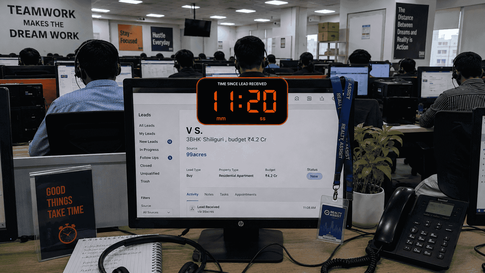 An Indian real-estate telecalling floor — agent workstations with a portal lead card and a stopwatch overlay past four minutes.